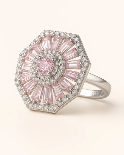 Pink gemstone ring with silver accents on a white background