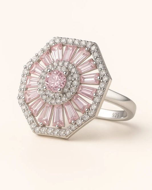 Pink gemstone ring with silver accents on a white background