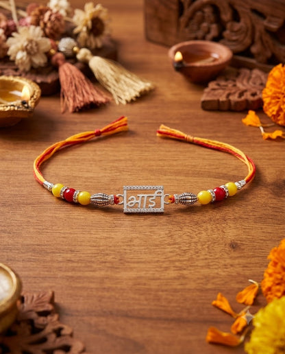 Rakhi bracelet with decorative elements on a wooden surface